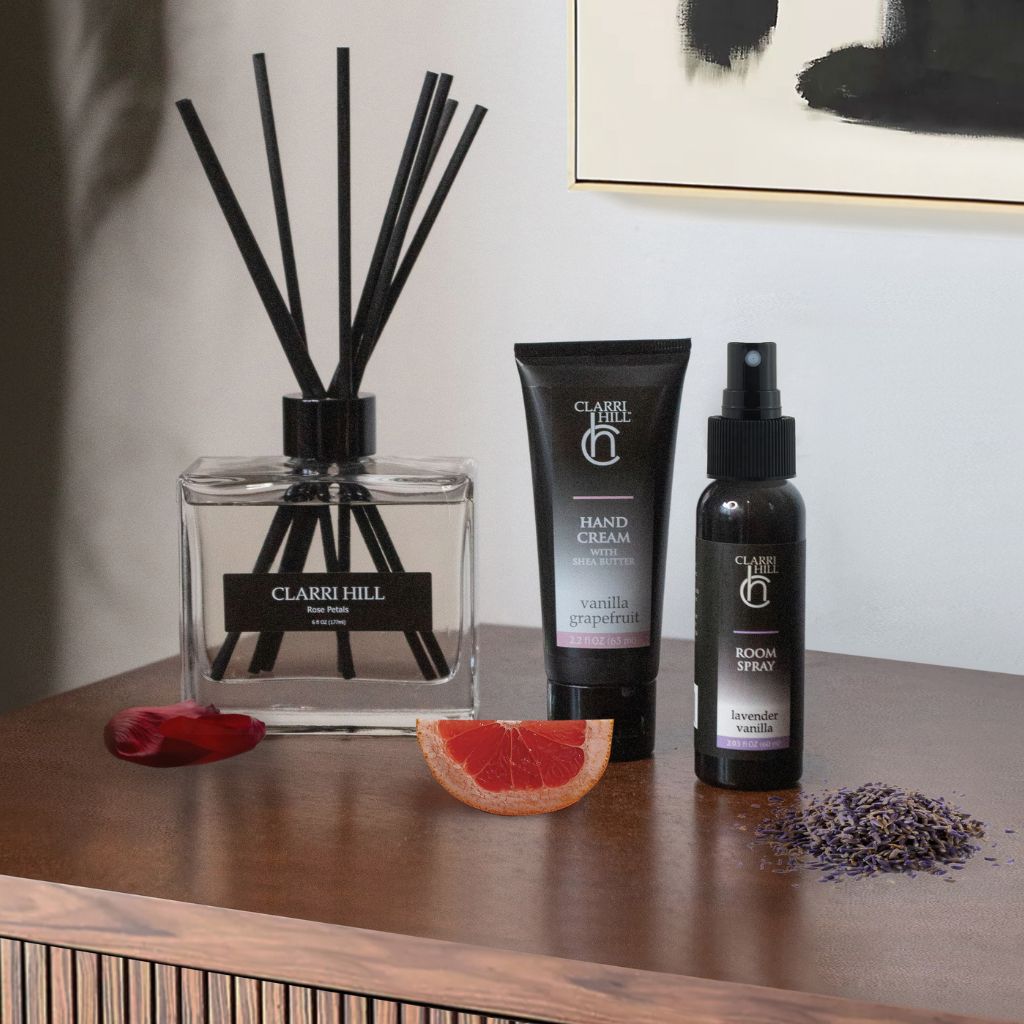 A collection of Clarri Hill's finest home fragrance products, including a reed diffuser, shea butter hand cream, and room spray, handcrafted with premium natural ingredients for a luxurious and eco-friendly experience.