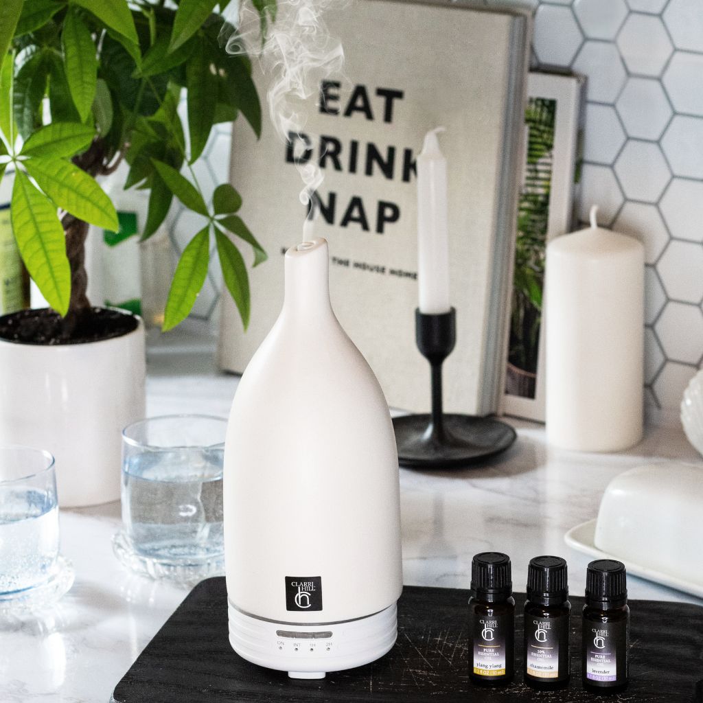 A photo of Clarri Hill's high-quality aroma diffuser and a collection of essential oils, designed to transform any room into a haven of peace and relaxation. Crafted with natural ingredients for a luxurious and eco-friendly experience