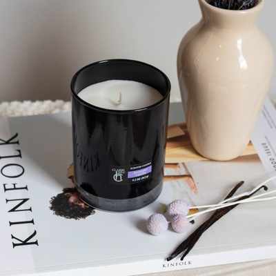 A photo of a black glass candle with a relaxing lavender vanilla scent, handcrafted by Clarri Hill with premium natural ingredients for the ultimate in home fragrance